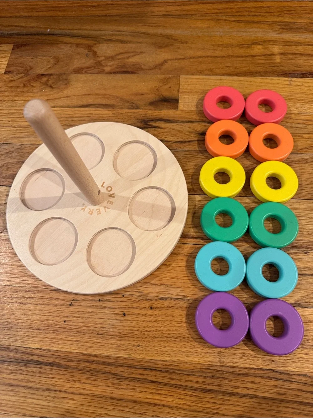 Flexible Wooden Ring Stacker with Rainbow Rings by Lovevery